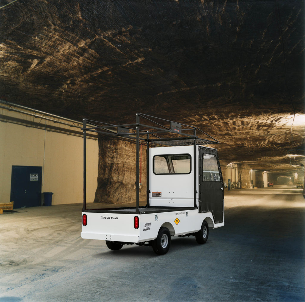White utility vehicle driving underground