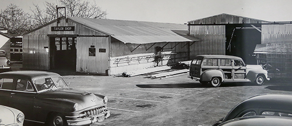 Vintage photo of old automobiles outside 