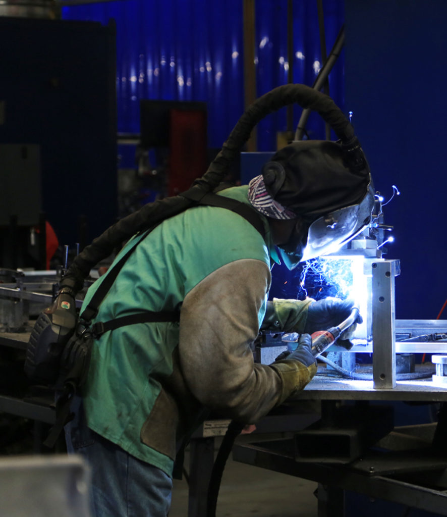 Man welding in warehouse